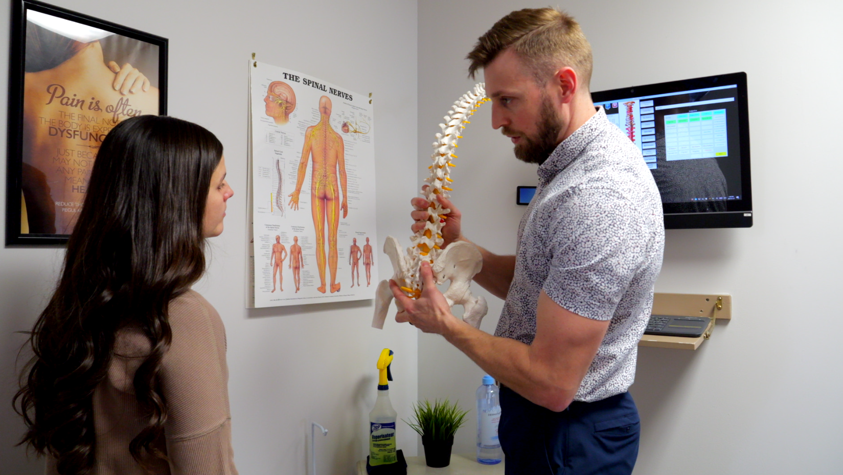 explaining low back with spine assessment Jessica New Patient Consult Dr. Ben Tucker Riverside Chiropractic London Chiropractor